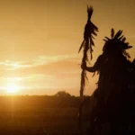 Native American looking at sunset.